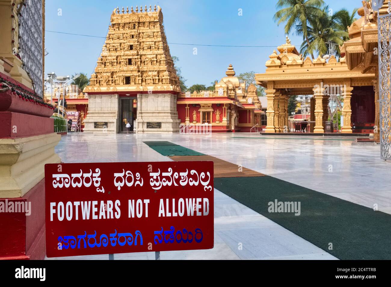 Sign at the entrance to Kudroli Shree Gokarnanatheshwara Temple, Mangalore, Karnataka, India, reminding footwear not being allowed in the premises Stock Photo