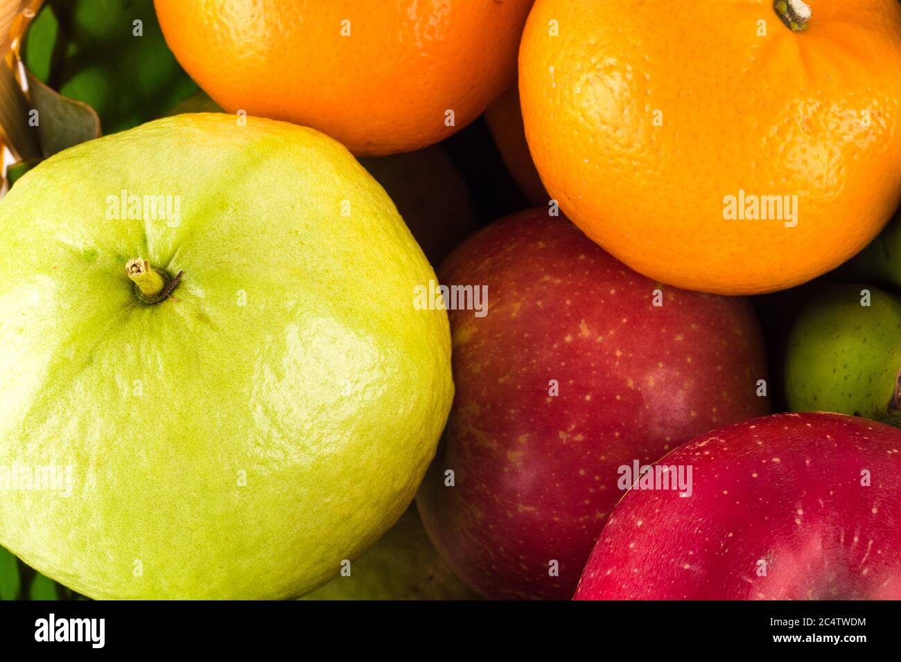 guava and orange and red apple are many fresh fruits mixed together on  background fruit health food Stock Photo