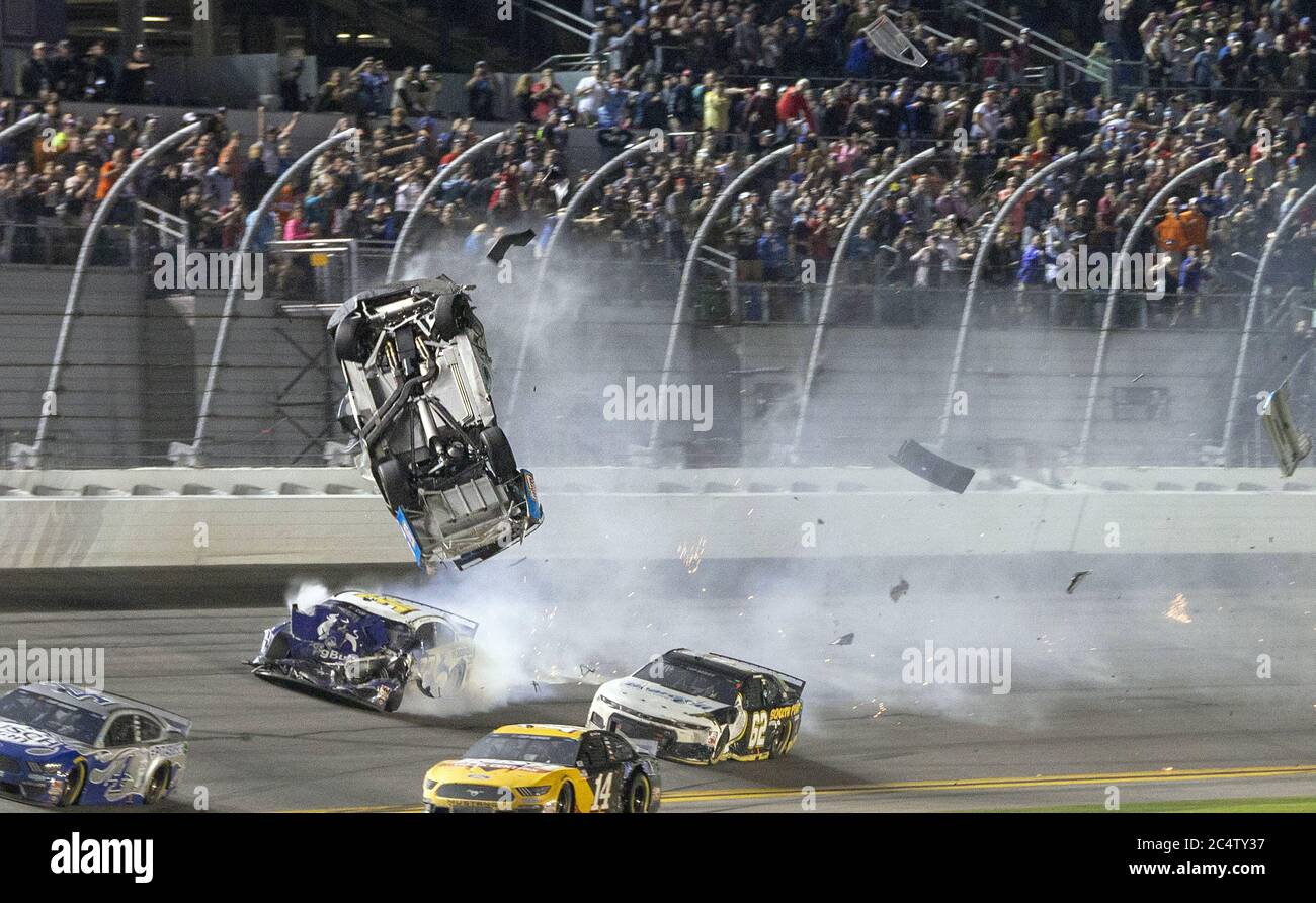 Daytona Beach, Florida, USA. 17th Feb, 2020. Newman flying after being in the lead coming into the final turn with Ryan Blaney, when Blaney's bumper caught the back of his Ford and sent Newman hard right into the wall. His car flipped, rolled, was hit on the driver's side by another car, and finally skidded across the finish line engulfed in flames. Meanwhile Daytona 500 winner Denny Hamlin close behind. Denny won his second straight Daytona 500 and third overall, beating Ryan Blaney in an overtime photo finish marred by the terrifying crash that sent Ryan Newman to the hospital on Monday. Stock Photo