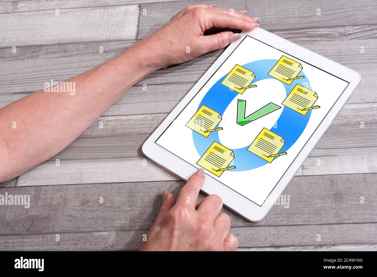 Document validation concept shown on a tablet used by a woman Stock Photo