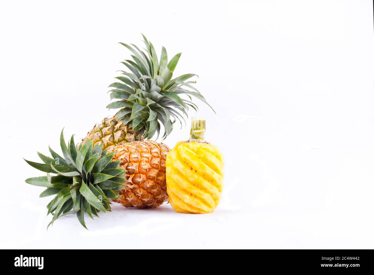 peeled  pineapple and fresh ripe pineapple  on white background healthy pineapple fruit food isolated Stock Photo