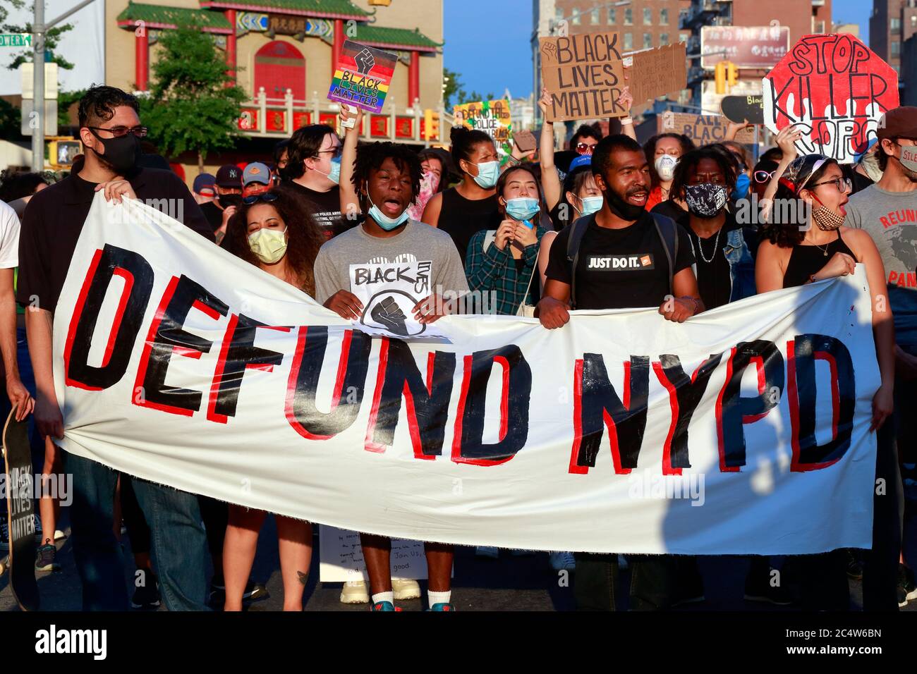 people-holding-a-defund-nypd-banner-at-a-protest-march-toward-city-hall-in-new-york-ny-june-25-2020-a-group-of-protesters-marches-along-canal-street-in-manhattan-toward-lower-manhattan-2C4W6BN.jpg