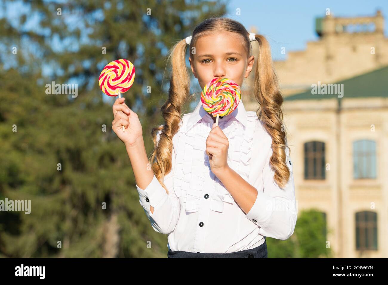 Lollipop melting in your mouth. Happy child eat lollipop summer