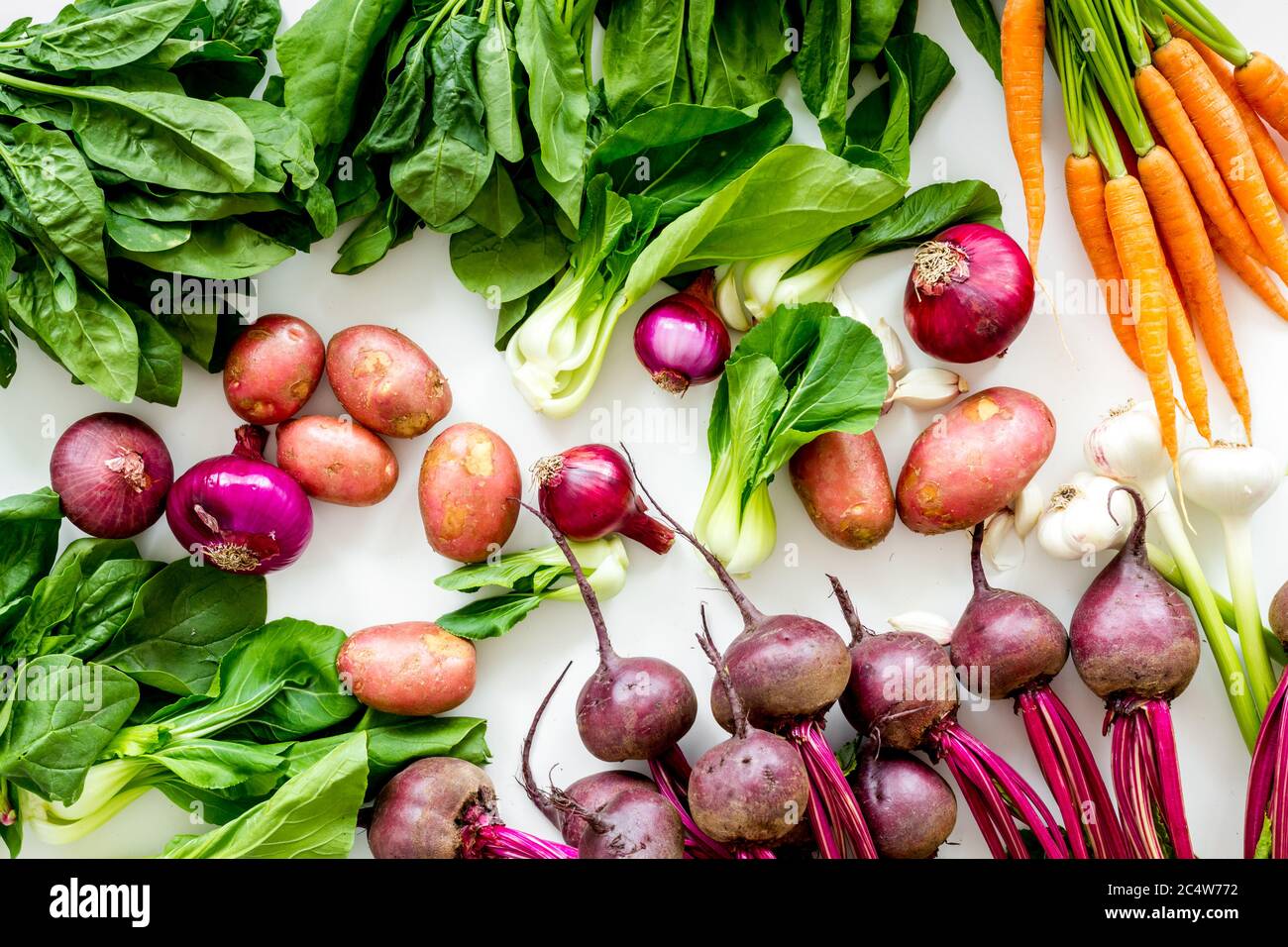 Carrot Potato Beet Onion And Spinach On White Background Top View Carrot Potato Beet Onion And Spinach On White Background Top View