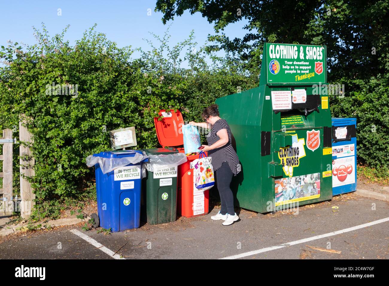 Woman emptying recycling into recycle, terracycle bins, uk Stock Photo