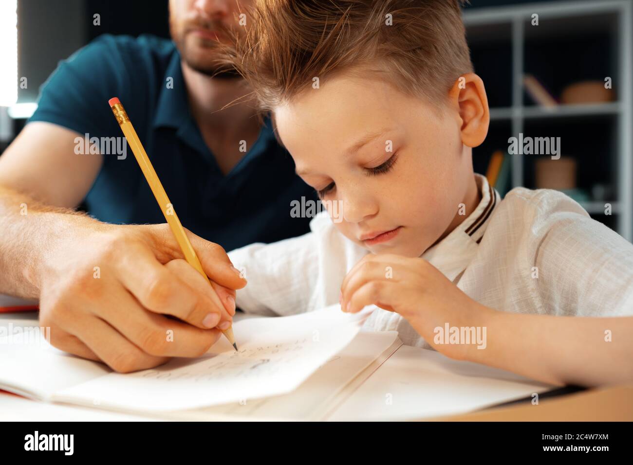 Father helping his little son with school homework Stock Photo - Alamy
