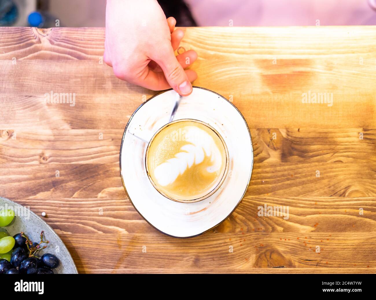 Cup of hot cappucino coffee on the wooden table. Early morning breakfast Stock Photo