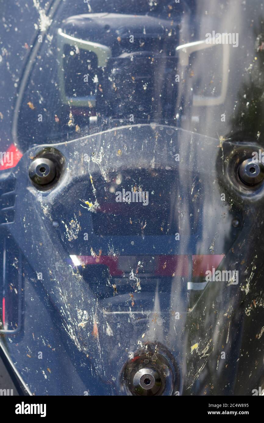 screws on a motorcycle windshield, windshield with a lot of dirt Stock Photo