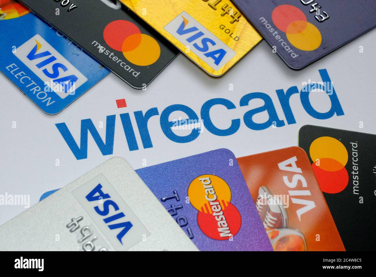 Wirecard logo on paper and VISA and MASTERCARD credit cards around it. Concept. Stock Photo