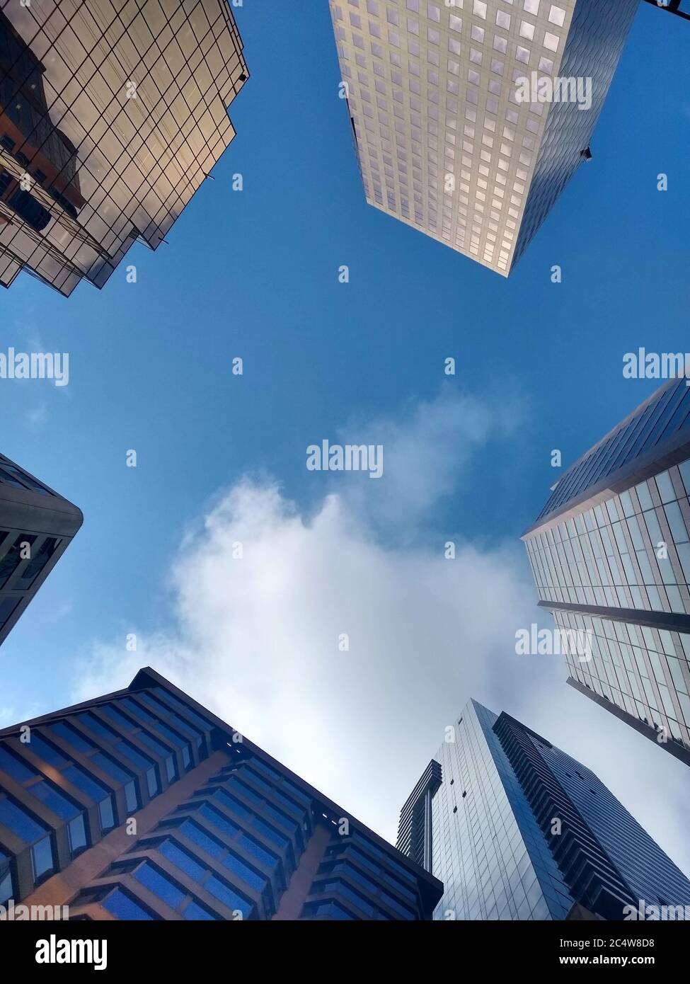 Low angle shot of a modern city with tall buildings Stock Photo - Alamy