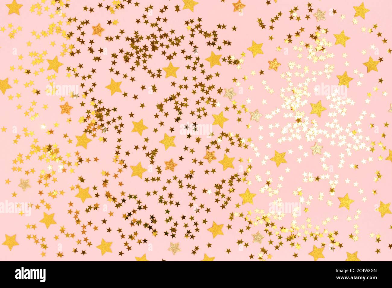 Shiny gold stars confetti on a pink pastel background. Festive glowing ...
