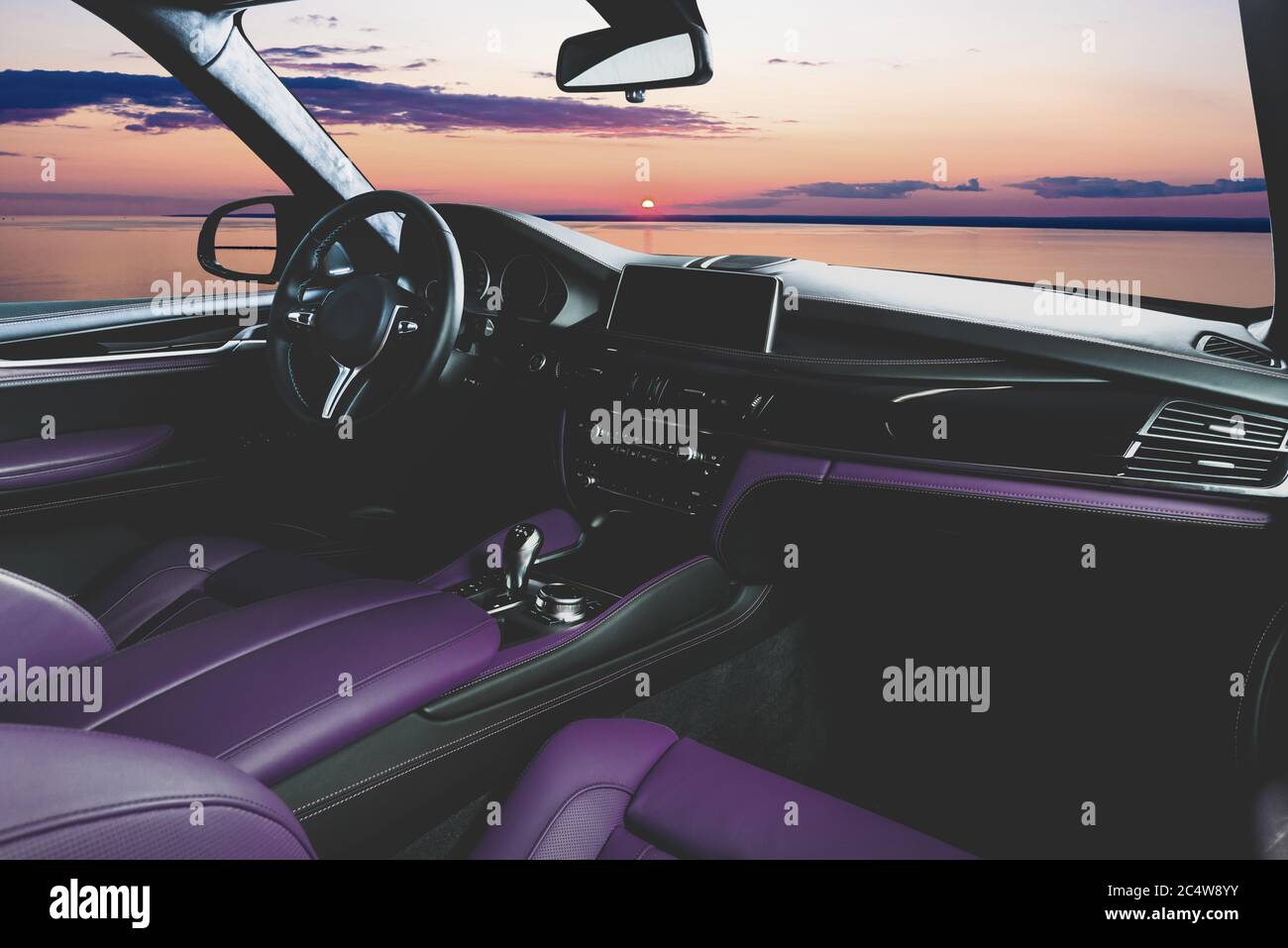Modern car interior with sunset in the windows Stock Photo