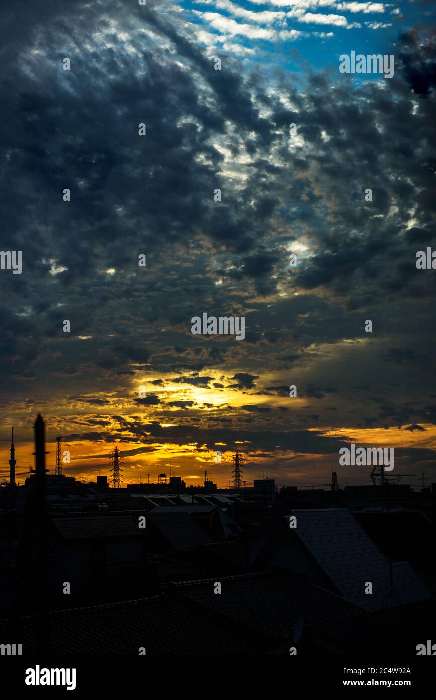 the sunset sky seen outside the window of a train running downtown Tokyo. Stock Photo