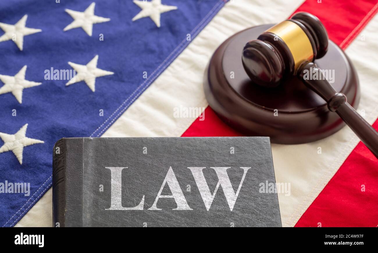 Law text on black book and judge gavel on US of America flag background. Justice in USA concept Stock Photo