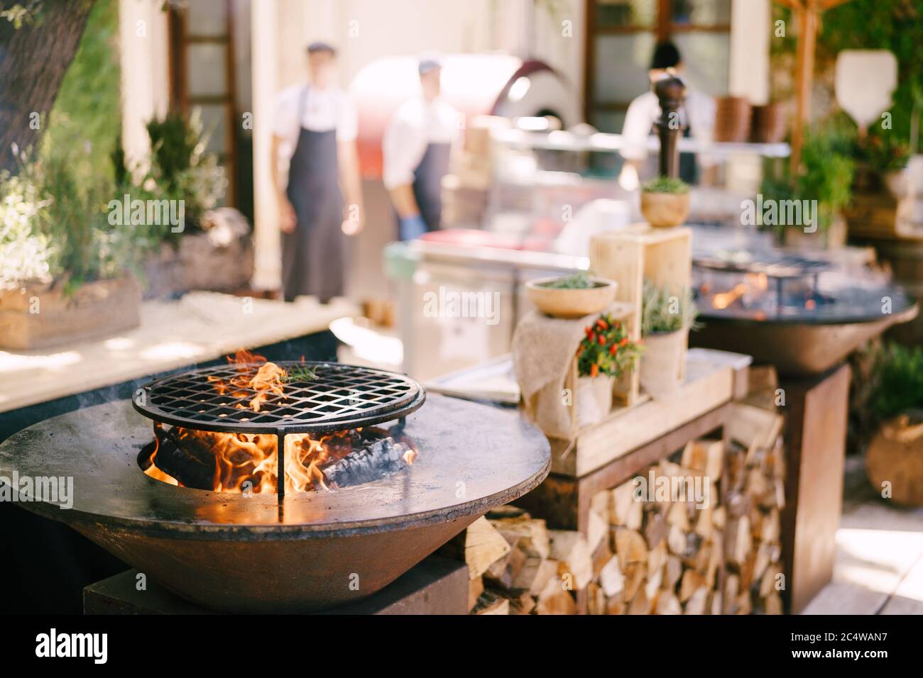 A bowlshaped grill with a hole in the center for a campfire Stock