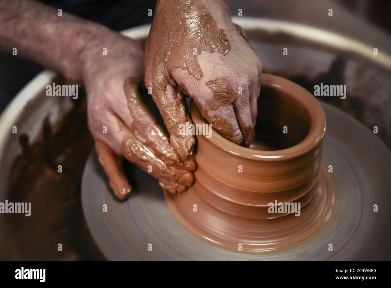 A day in the life of a pottery artist - at the pottery wheel. Stock Photo