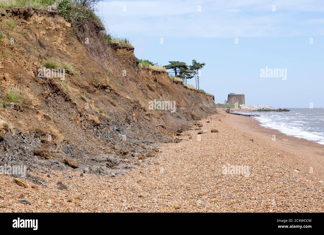 Mass movement collapse soft cliffs  coastal erosion at East Lane, Bawdsey, Suffolk, England, UK - Martello tower Stock Photo