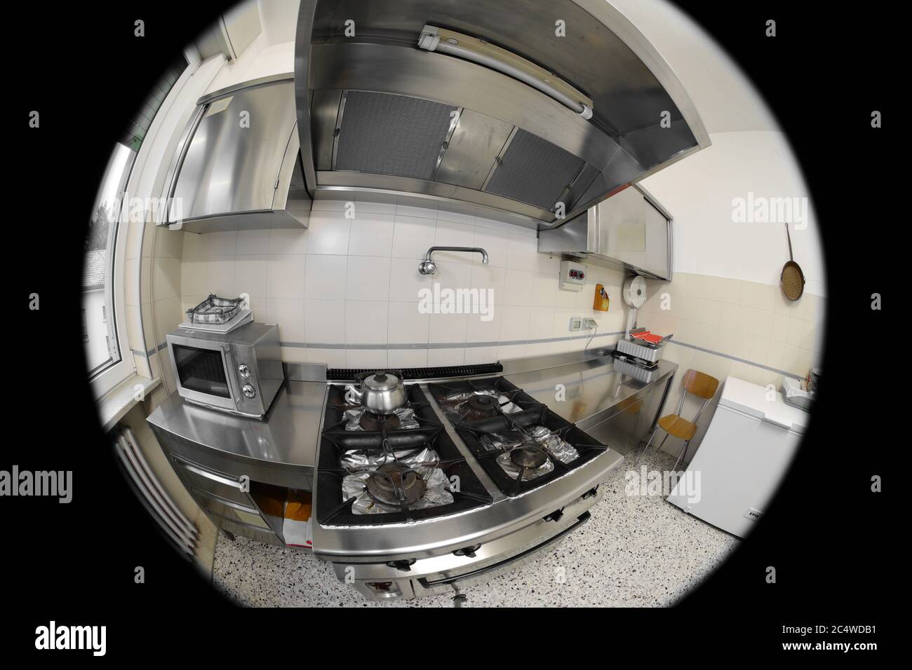 interior of the kitchen of a restaurant with the stove seen by a