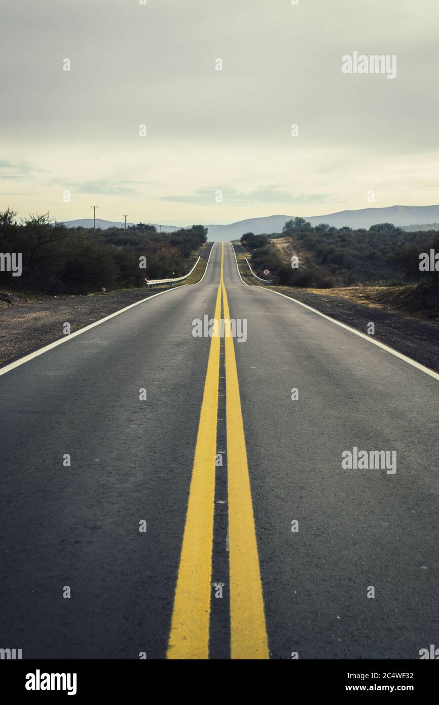 Empty highway surrounded hills hi-res stock photography and images - Alamy