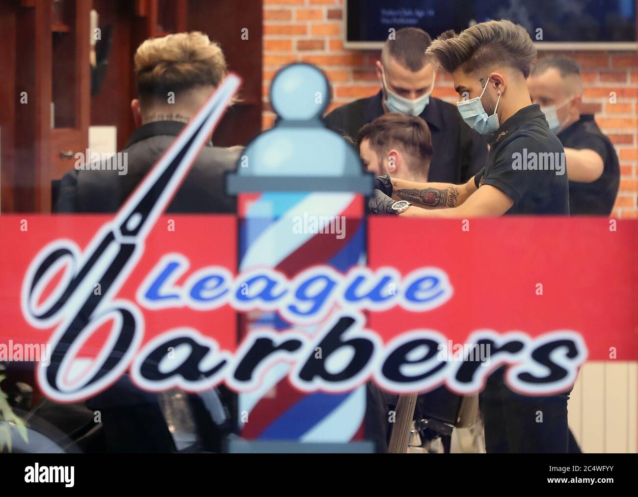 People getting their hair cut at the League Barbers in Athy, Co Kildare, as Ireland enters phase three of Covid-19 lockdown restrictions. Stock Photo