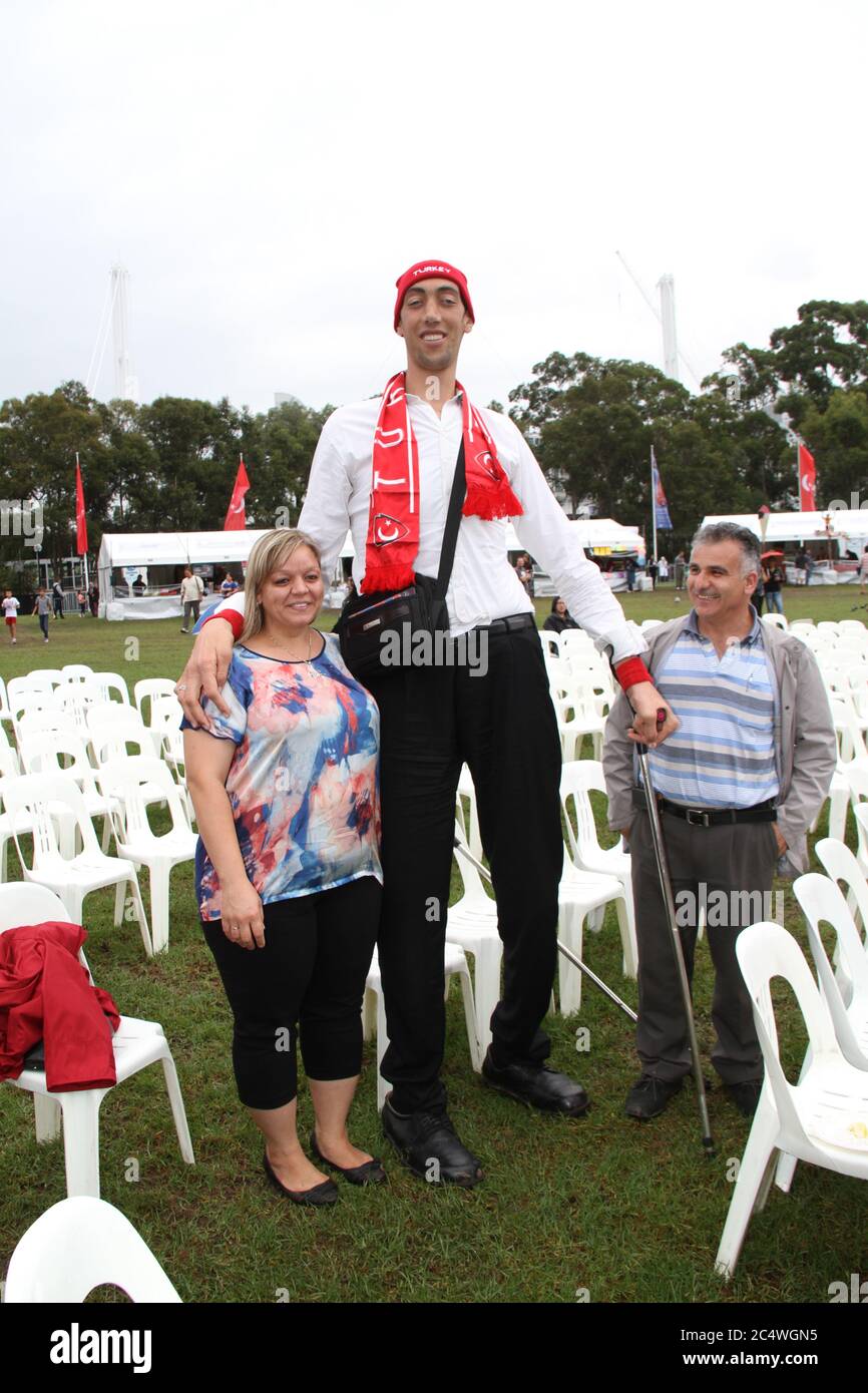 People have their photo taken with the world’s tallest man, Sultan Kosen from Turkey at the Anatolian Turkish Festival in Sydney. Stock Photo