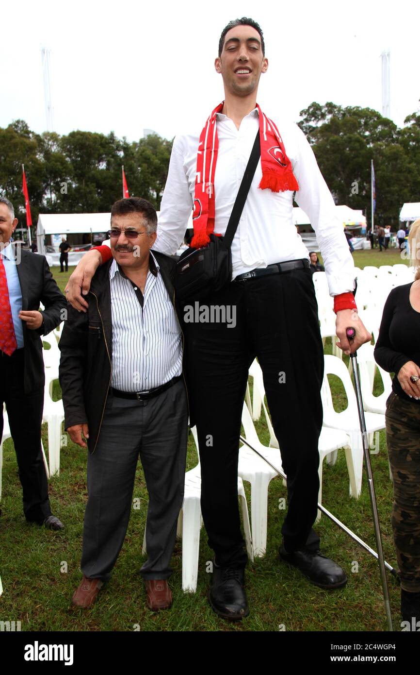 People have their photo taken with the world’s tallest man, Sultan Kosen from Turkey at the Anatolian Turkish Festival in Sydney. Stock Photo