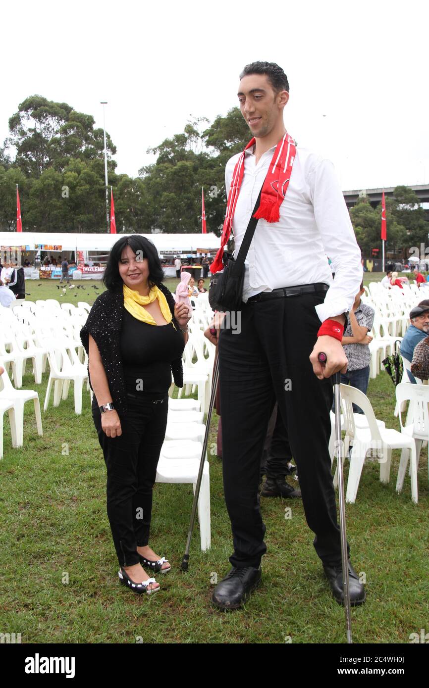 People have their photo taken with the world’s tallest man, Sultan