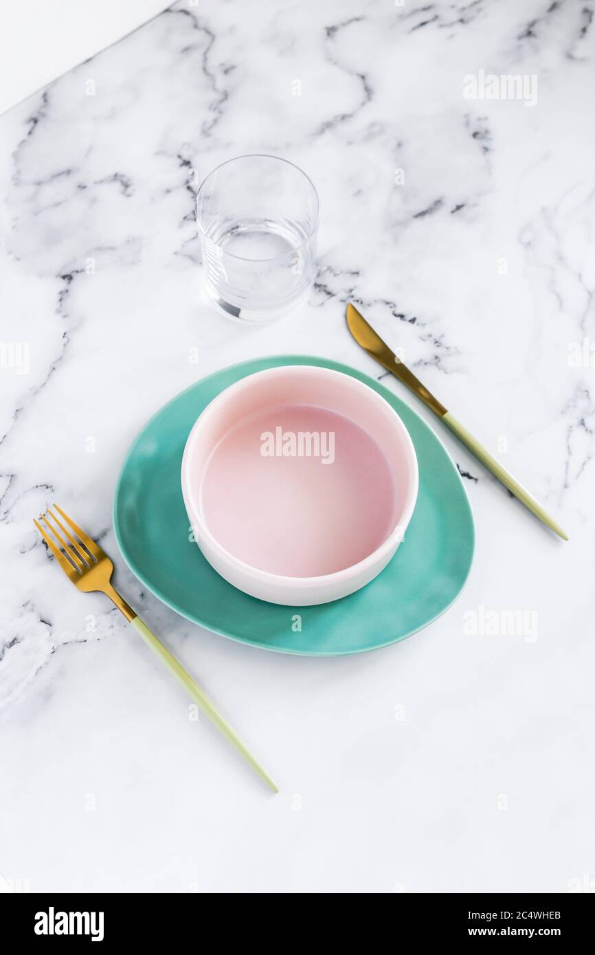 Stylish elegant table setting with ceramic plates on white marble background Stock Photo