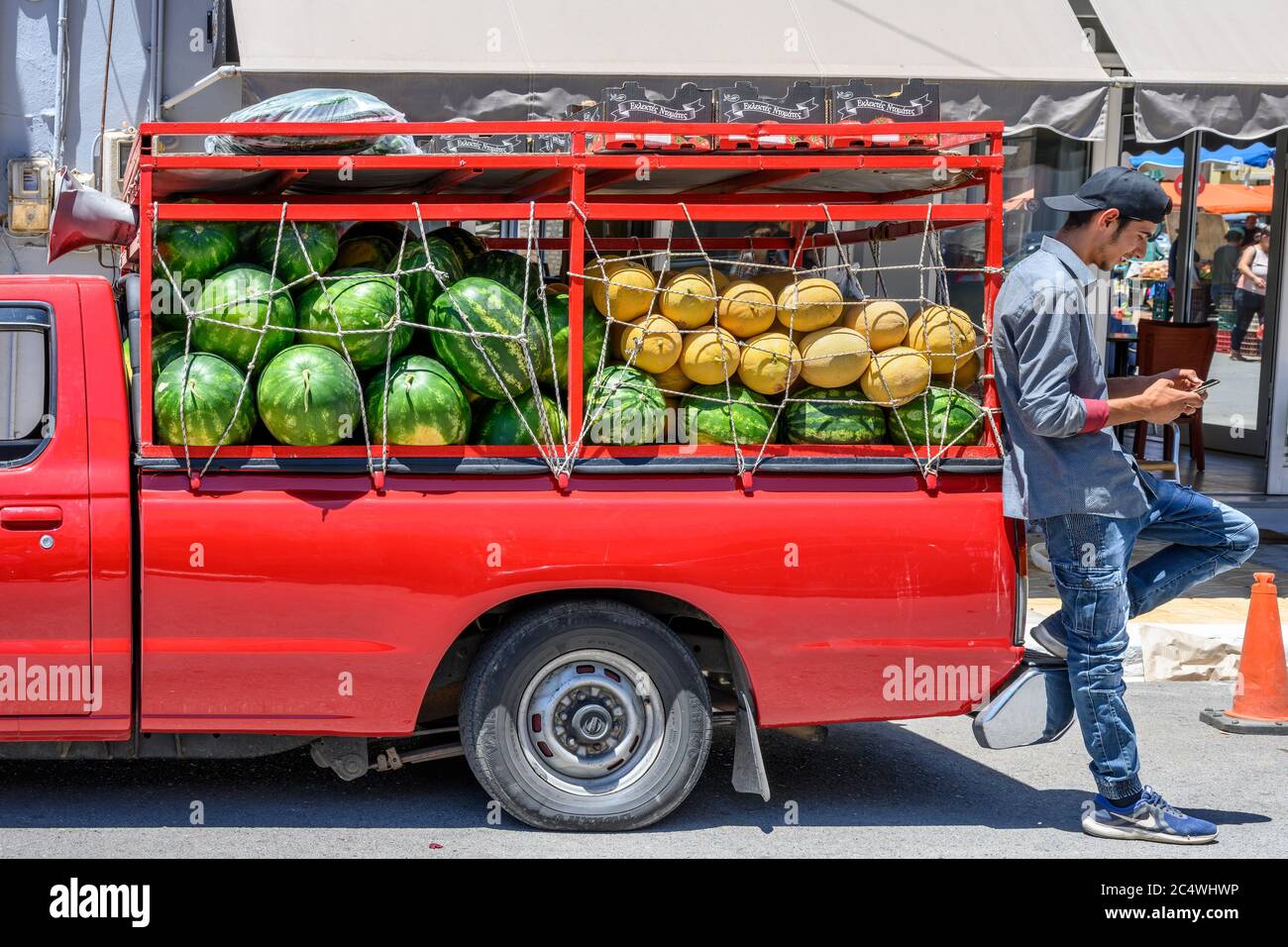 Selling melons from a pickup truck at the Sunday market in the small town of Kopanaki, northwestern Messinia, Peloponnese, Greece. Stock Photo