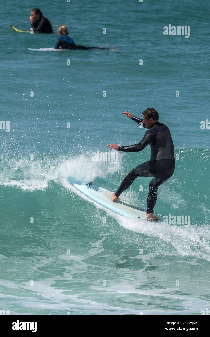 Surfing action at Fistral in Newquay in Cornwall. Stock Photo