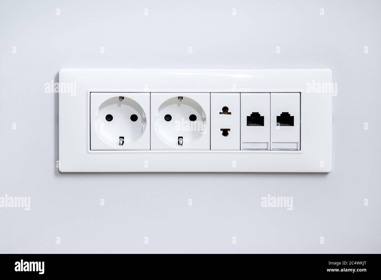 a socket on a light gray wall, a multifunction outlet with an internet  connection, two European-style outlets and one American type outlet Stock  Photo - Alamy