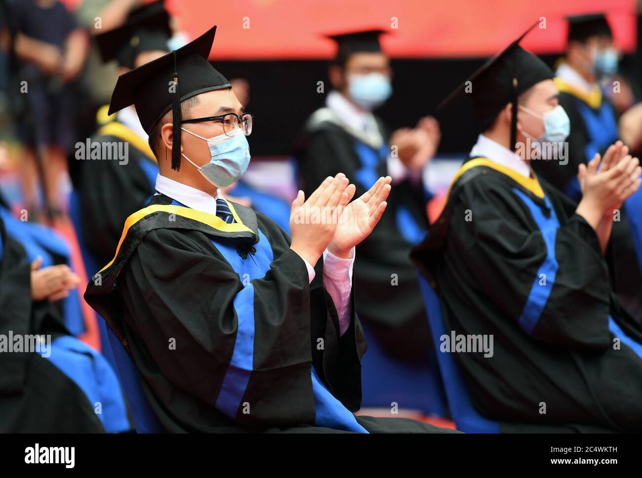 Beijing, China. 29th June, 2020. Graduates attend the commencement ceremony at Beihang University in Beijing, capital of China, June 29, 2020. Beihang University held a commencement ceremony for the Class of 2020 (Bachelor's Degrees) on Monday. In order to reduce the risk of infection of COVID-19, only a minority of graduates attended the ceremony on site with the others attending online. Credit: Ren Chao/Xinhua/Alamy Live News Stock Photo