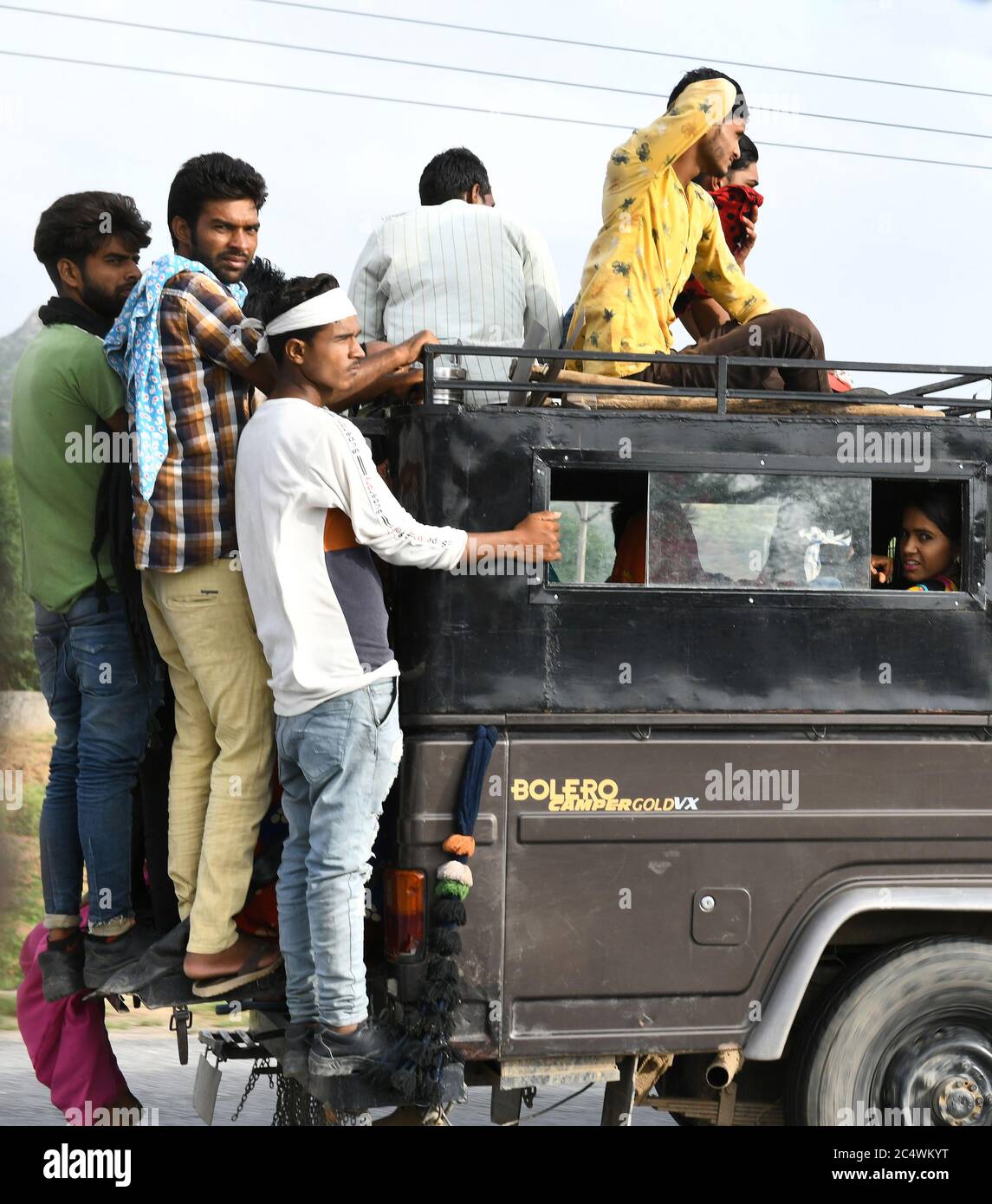 Beawar, Rajasthan, India, June 29, 2020: People travel in an overloaded private taxi on national highway 8 during Unlock 1.0 in Beawar. Drivers are putting the life of passengers to risk by overloading vehicles due to not running regular government bus. Credit: Sumit Saraswat/Alamy Live News Stock Photo