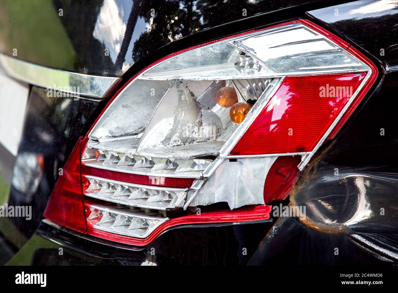 broken rear headlight closeup side view of the damage to the car in an