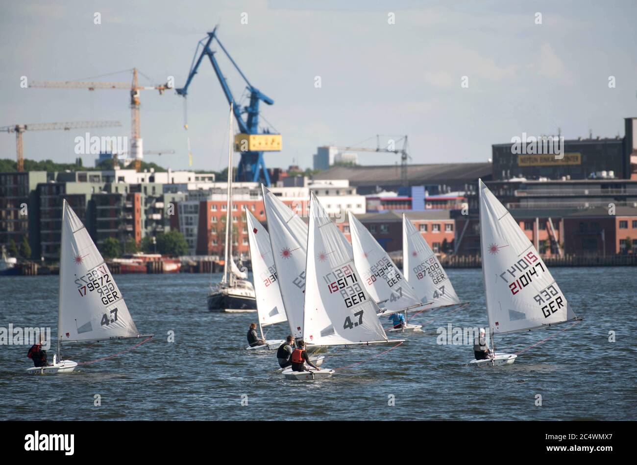 Rostock, Germany. 25th June, 2020. Optimist dinghies train on the Warnow in Rostock. With this small and light dinghy, children and young people train for regatta sports in the Hanseatic city. Credit: Nordlicht Rostock/dpa-Zentralbild/ZB/dpa/Alamy Live News Stock Photo