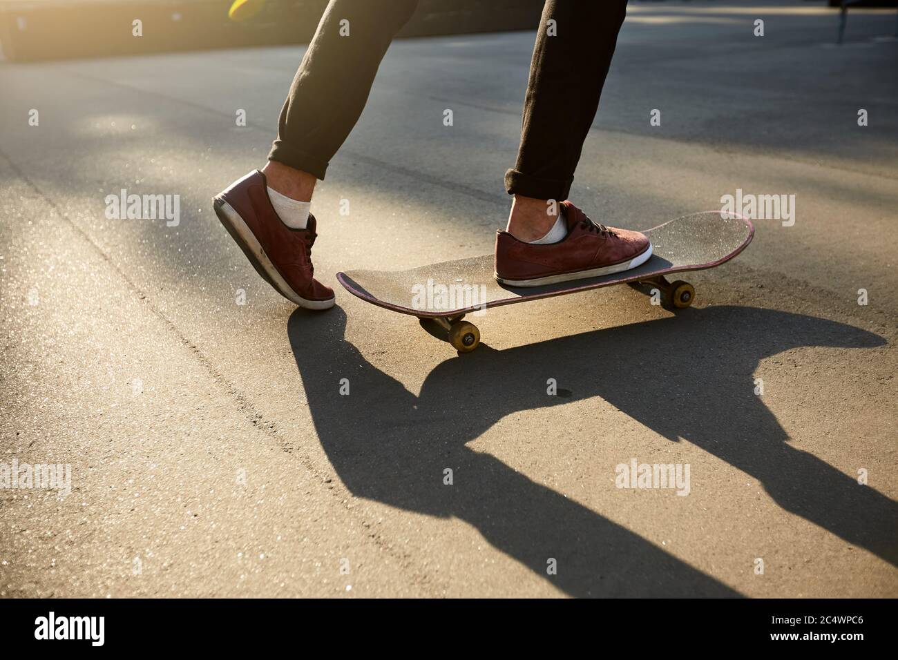 Closeup of skateboarders feet while skating in skate park. Man riding