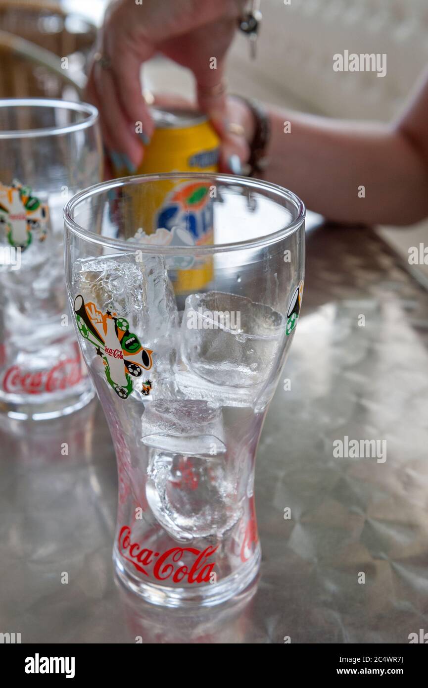 Ice in a coca cola branded glass on a Taverna table Greece Stock Photo
