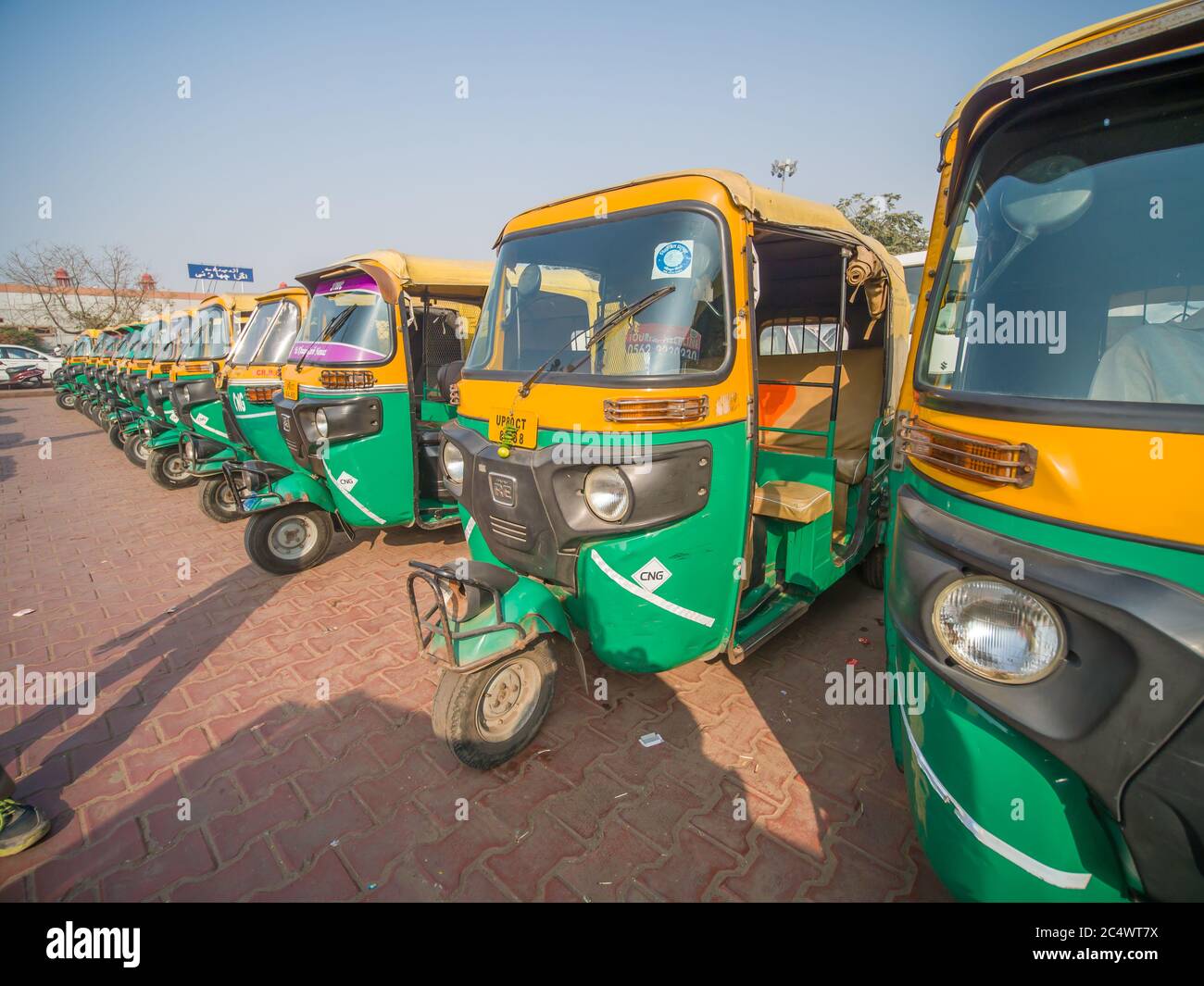 Mumbai, India - December 17, 2019: Yellow and green auto rickshaws in Indiya. Stock Photo
