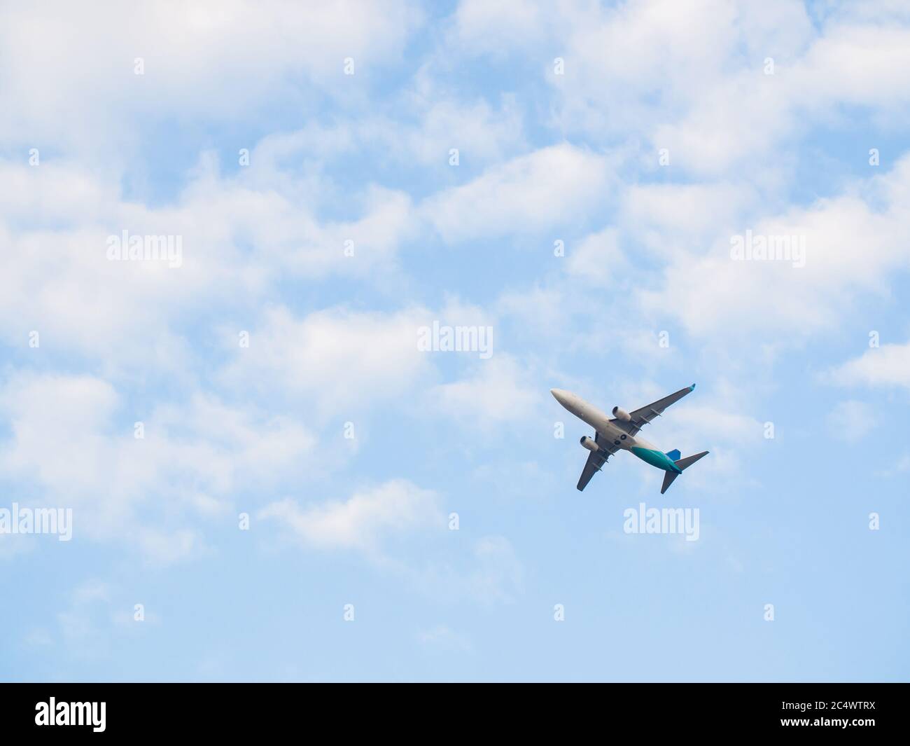 Passenger airplane takes off against the blue sky with clouds Stock ...