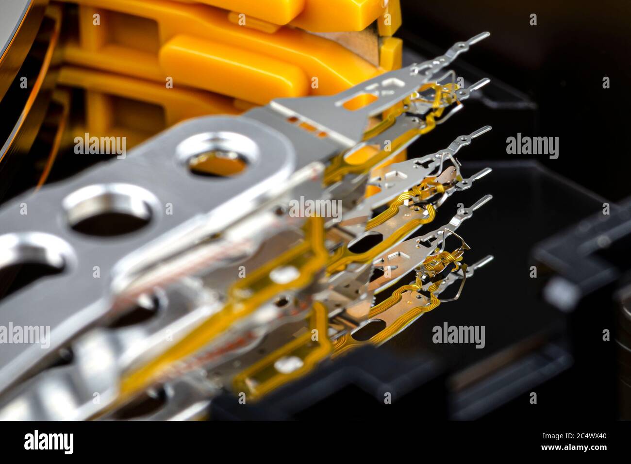Macro shot of three magnetic needles inside an open hard disk, parked position. Stock Photo