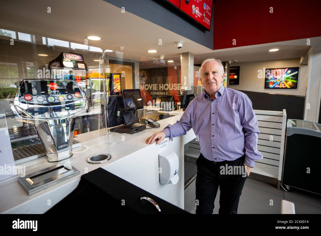 Michael McAdam, managing director of Movie House Cinemas in Northern Ireland, in his cinema in Glengormley, showing the newly installed screens and guards to protect and reassure staff and customers. Stock Photo