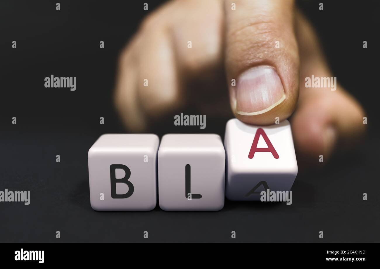 BLA Changes to BLA - False promises Concept. Hand Turns a Dice and Changes the Word bla to bla. Stock Photo