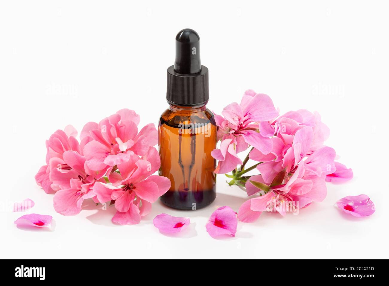 Geranium essential oil on amber bottle isolated on white background. Herbal oil Stock Photo