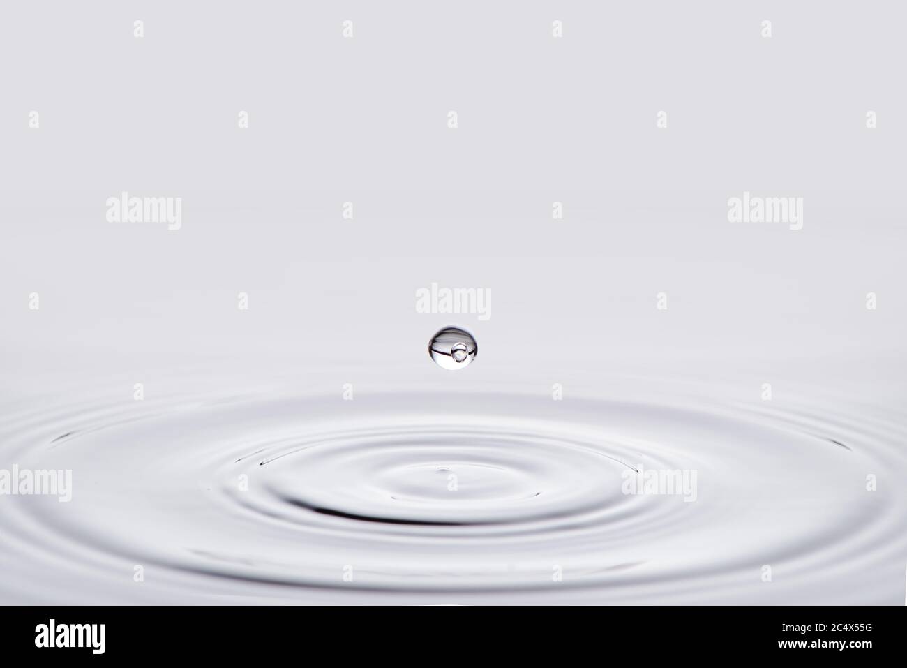 Close-up white water drop falling down. Stock Photo