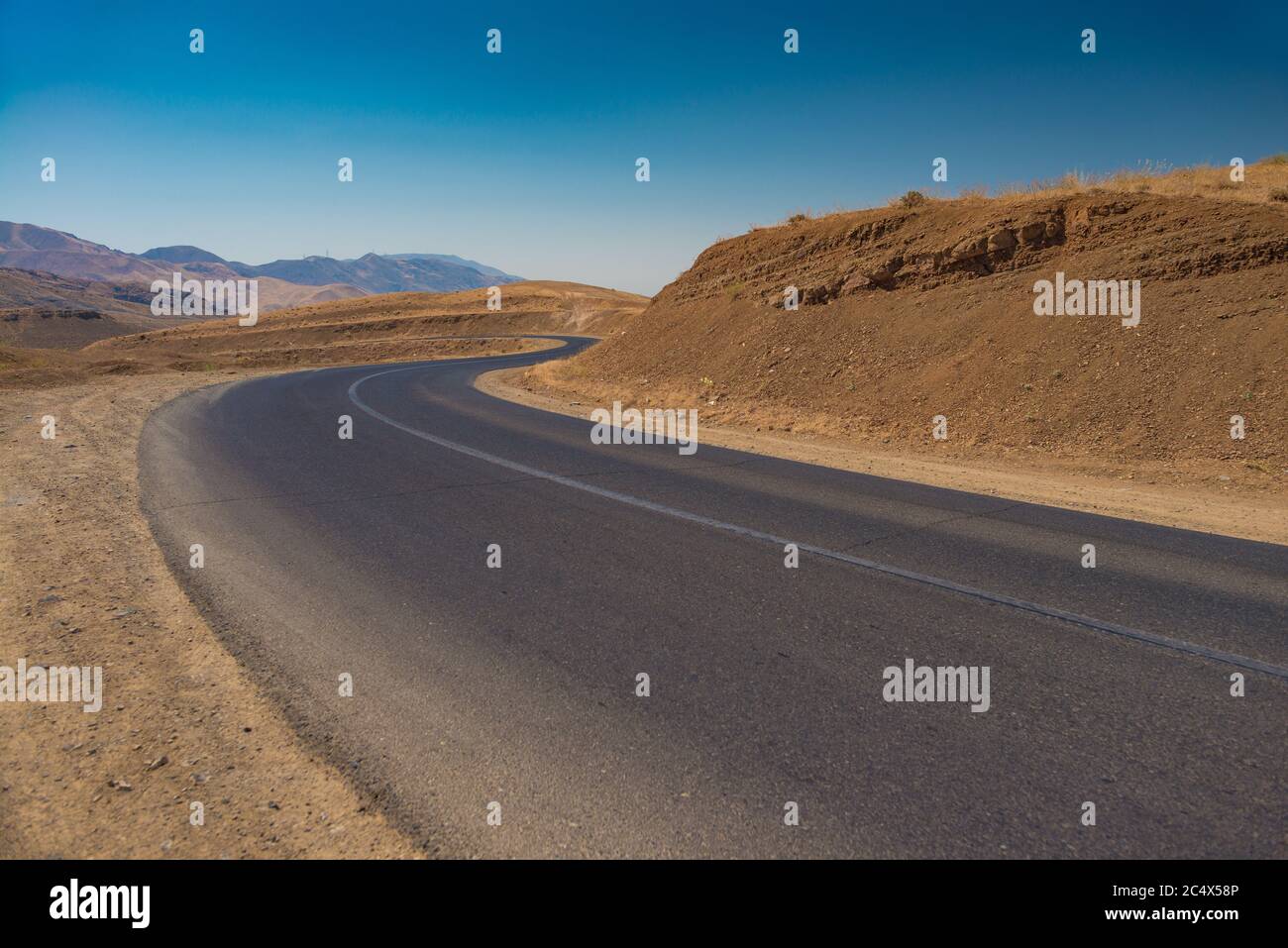 Long winding deserted road in Iran Stock Photo