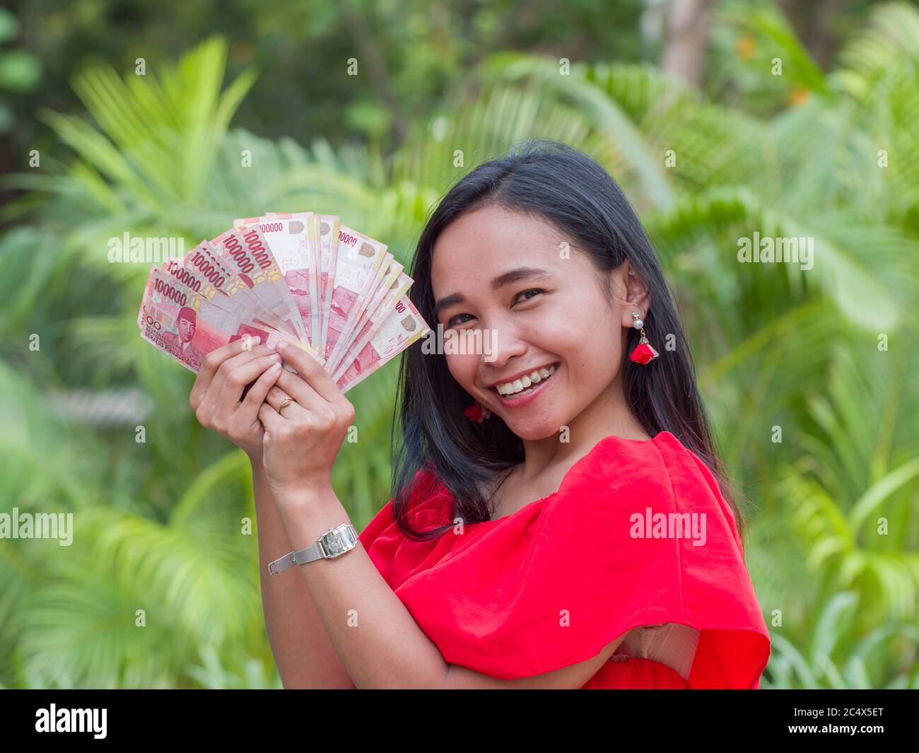 Indonesian money in the hands of an asian girl. Stock Photo