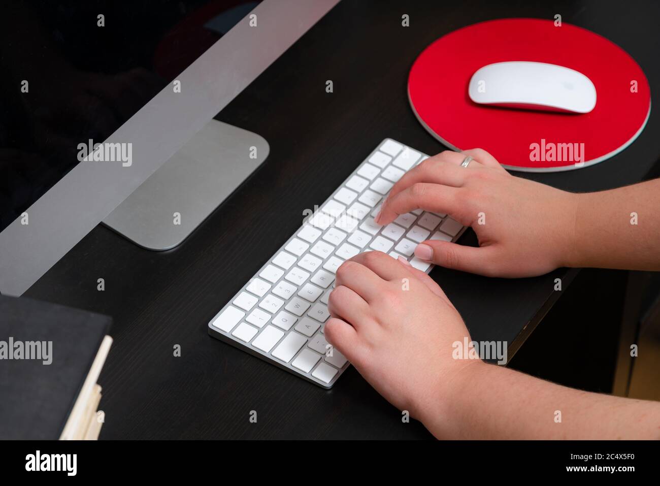 Close up of hands typing keyboard and using mouse at the office ...