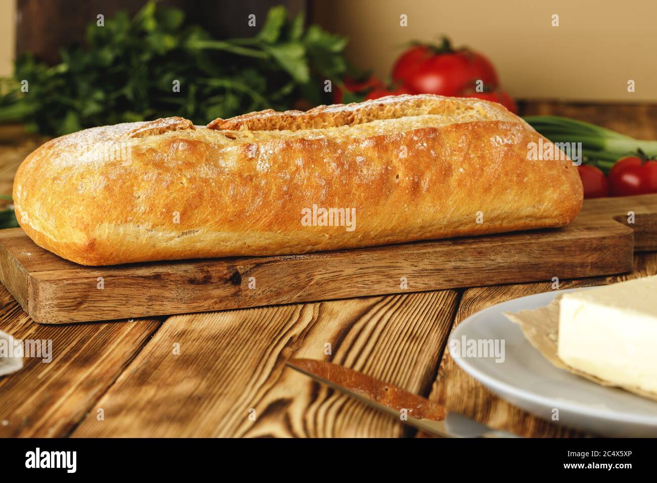 Fresh baked loaf of bread with butter bar Stock Photo Alamy