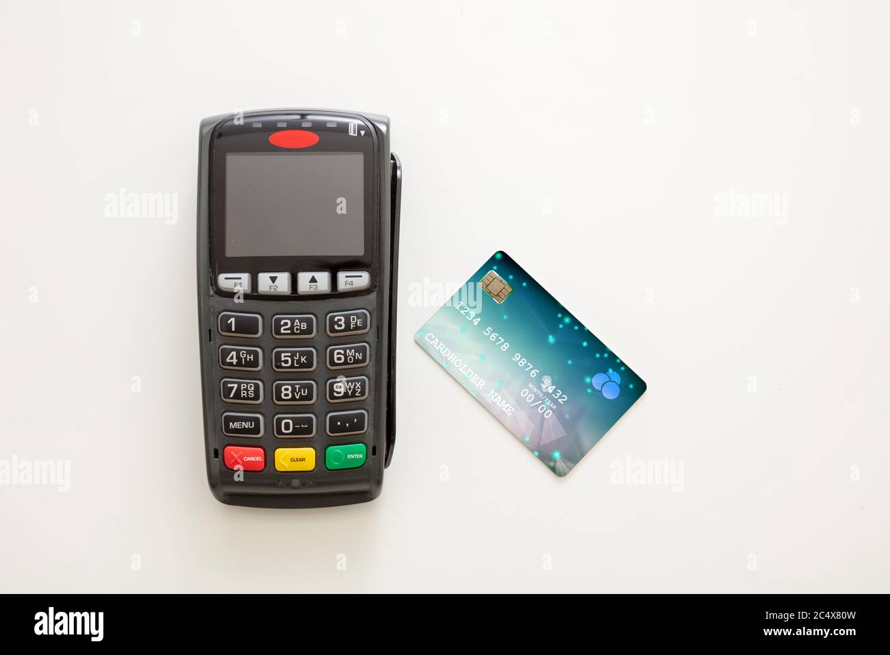 POS terminal and credit card isolated on white background, top view.Terminal cash register machine for contactless payment. Banking equipment, NFC. Stock Photo