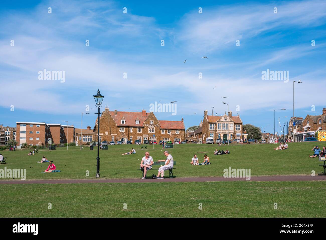 Hunstanton Green, view in summer of people relaxing on The Green in the